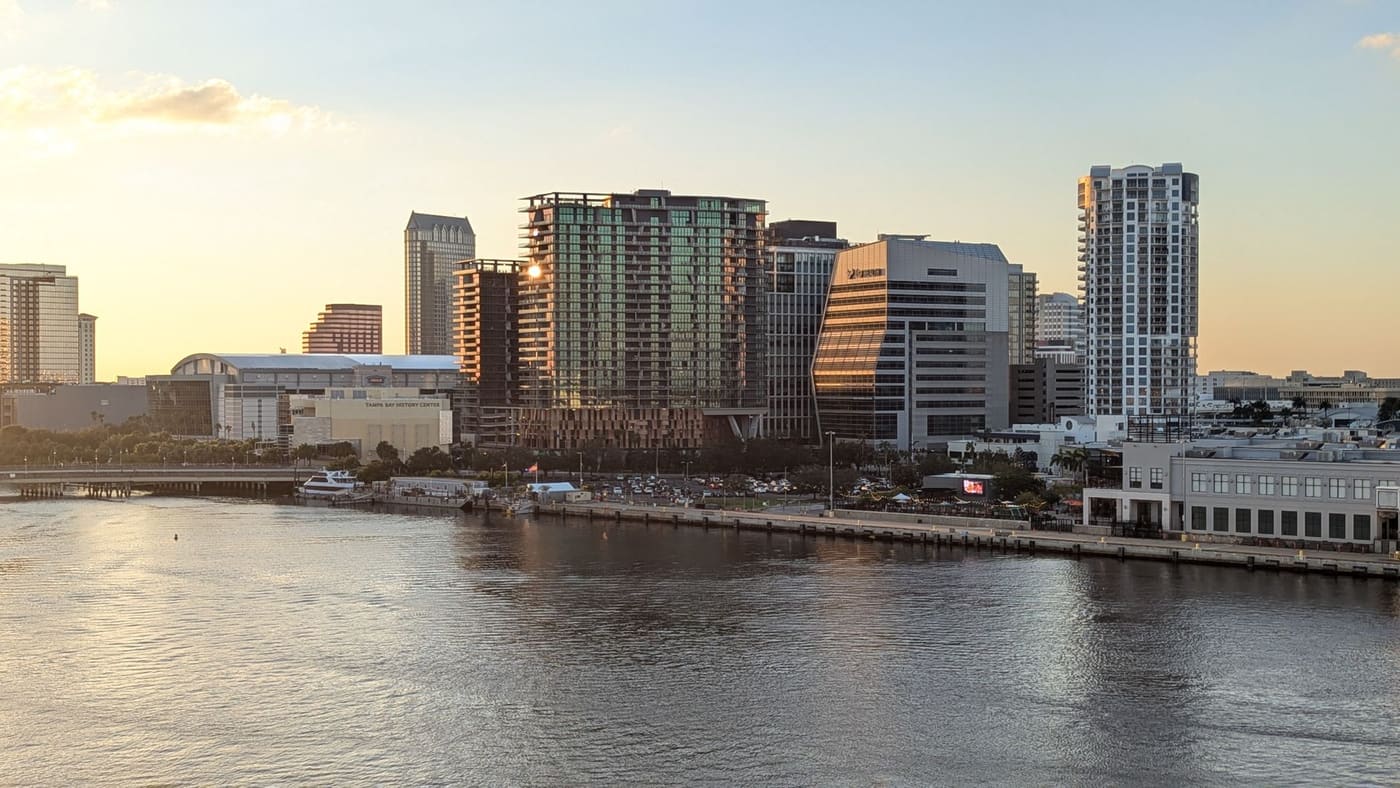 Downtown Tampa's waterfront towers glowing at sunset across the Hillsborough River